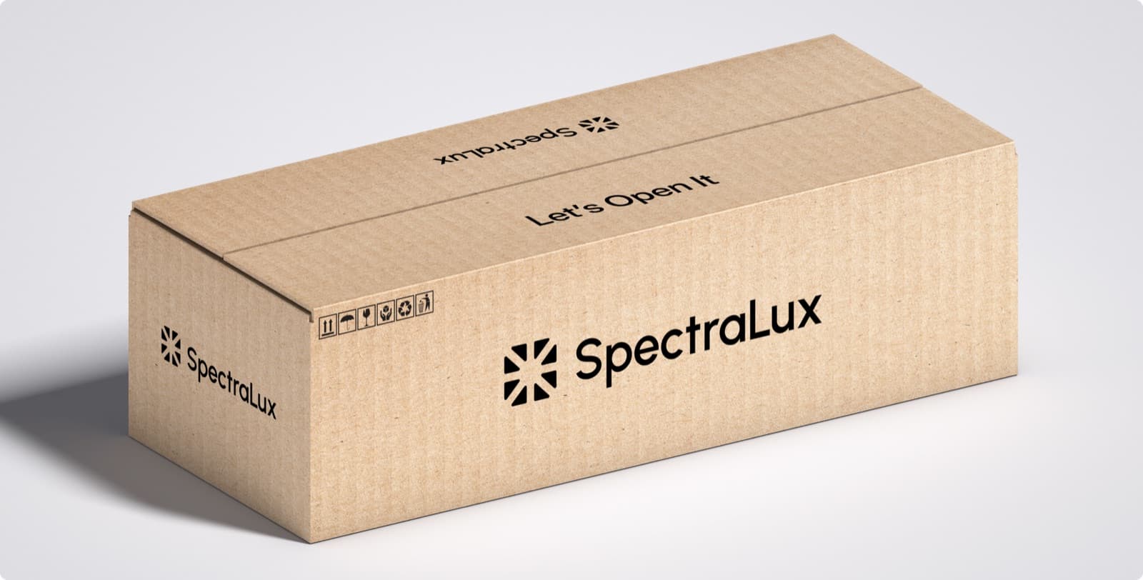A cardboard shipping box printed with the SpectraLux mark and wordmark and the line Let’s Open It
