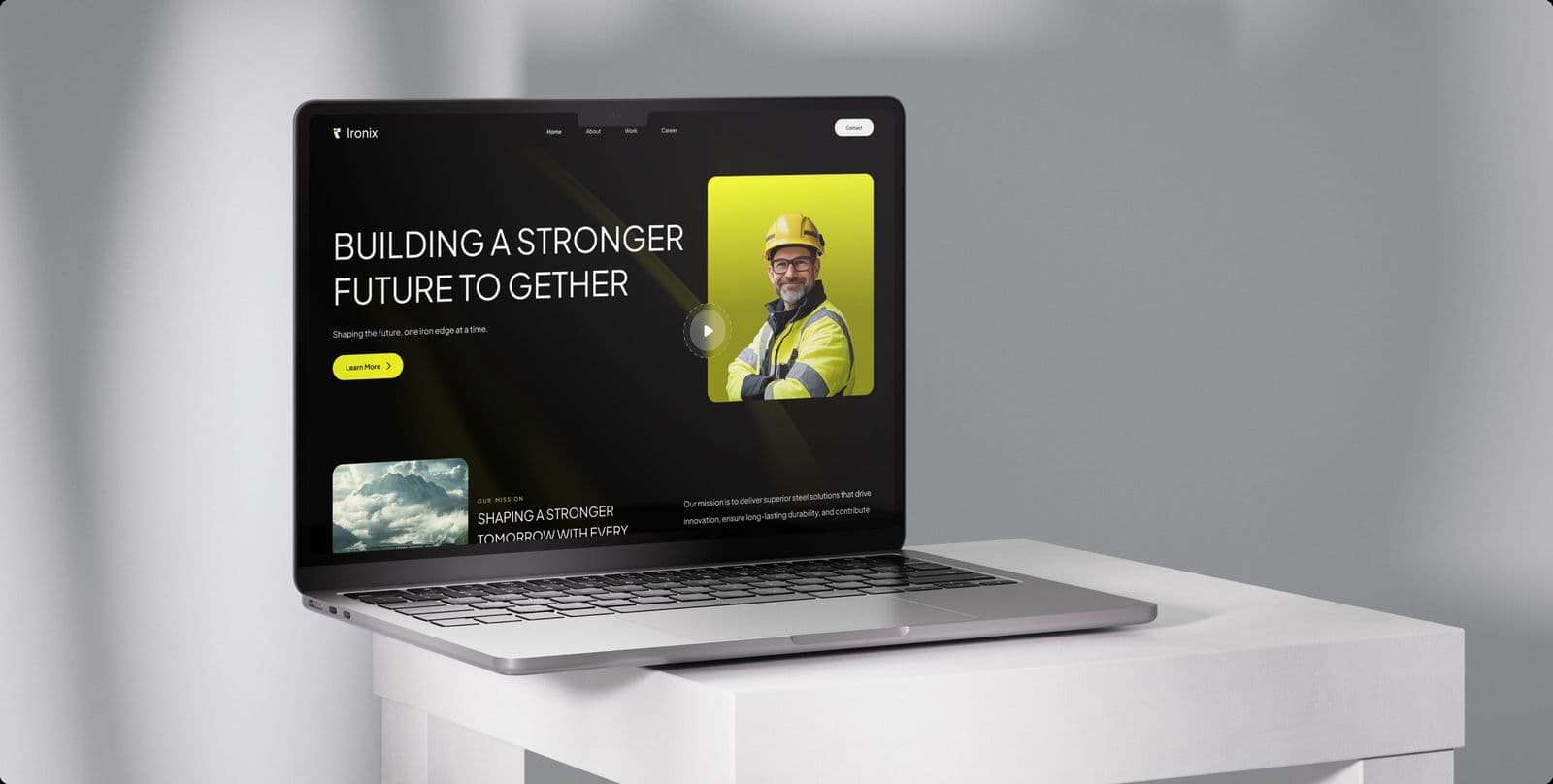The Ironix homepage on a laptop standing on a white plinth
