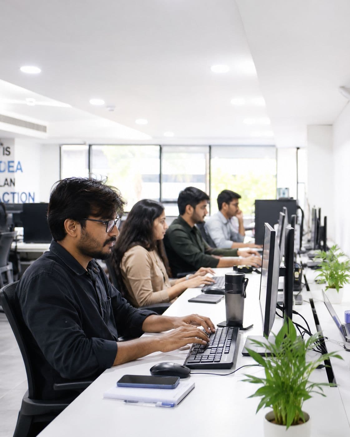 Redlio Labs engineers building client systems at a row of workstations