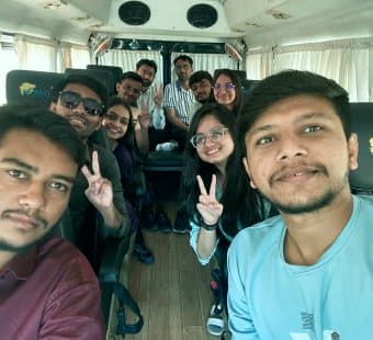Team members taking a selfie on a bus on the way to a day out