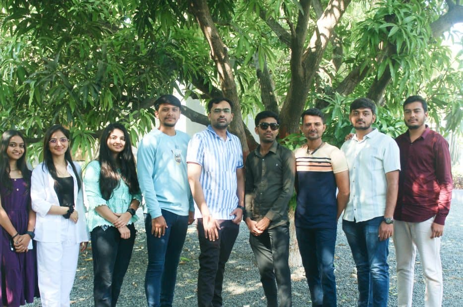 The Redlio Labs team standing in a row under a tree