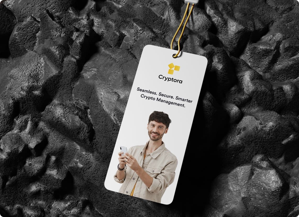 The Cryptora mark and wordmark on a paper swing tag