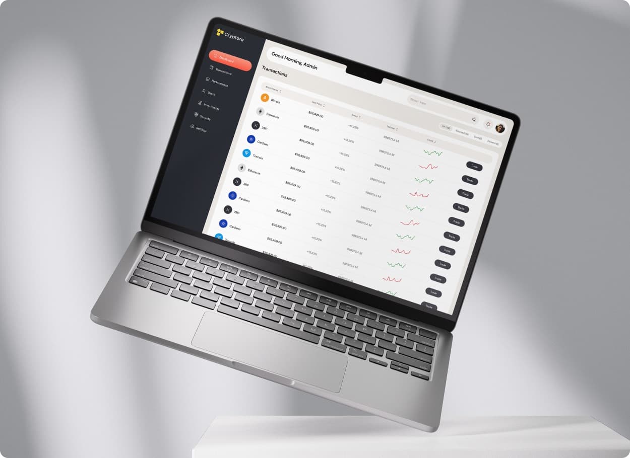 The Cryptora transactions view on a tilted laptop, listing coins with price, trend, volume and a trade button