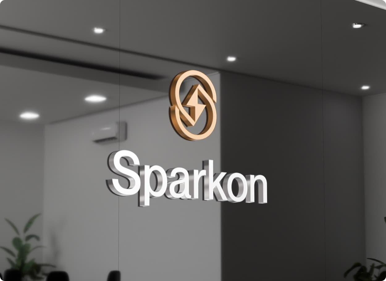 The Sparkon mark in copper above the wordmark in raised silver letters, in an office interior
