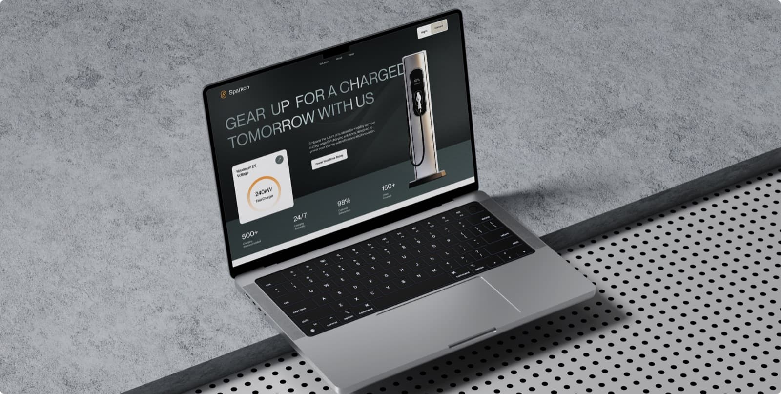 The Sparkon website on a laptop, with the headline Gear Up for a Charged Tomorrow With Us beside a charging station