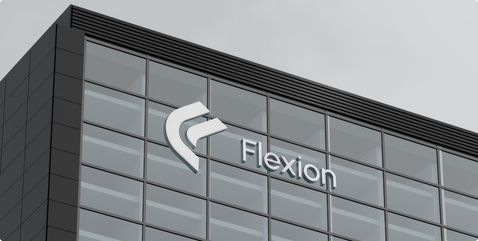 The Flexion mark and name as raised white letters on the glass front of a dark building