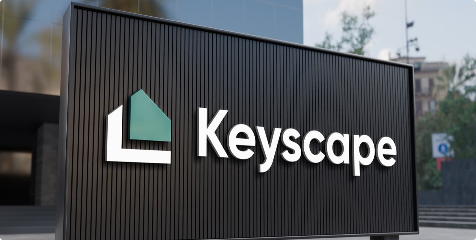 The Keyscape house mark and wordmark in raised letters on a black slatted sign outside a building