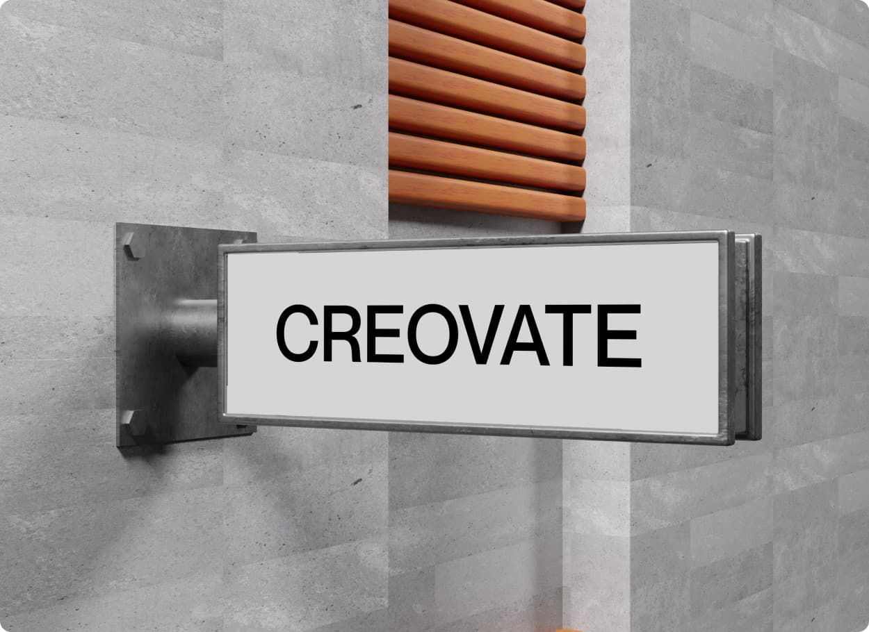The Creovate wordmark on a projecting sign fixed to a stone wall