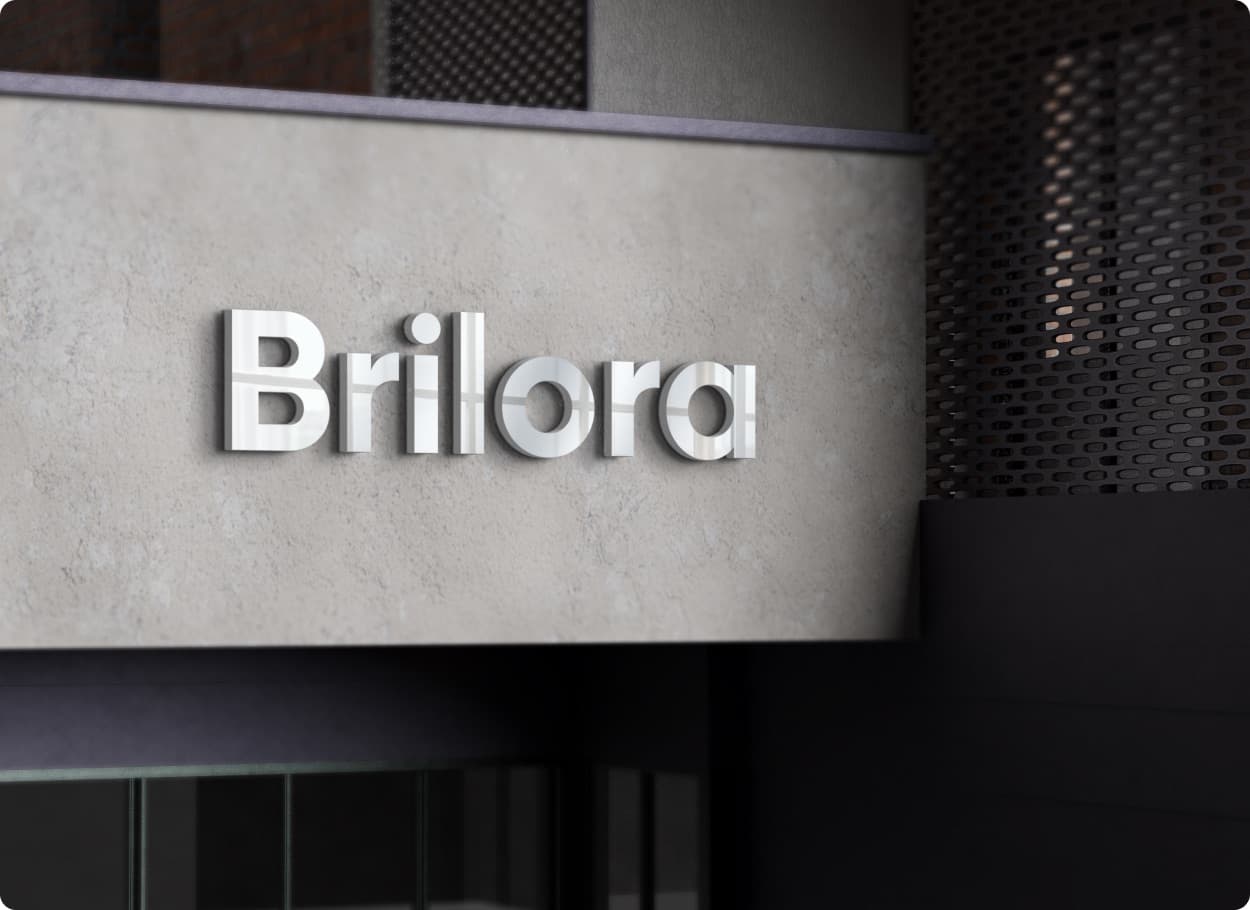 The Brilora wordmark in metal letters on a concrete building front