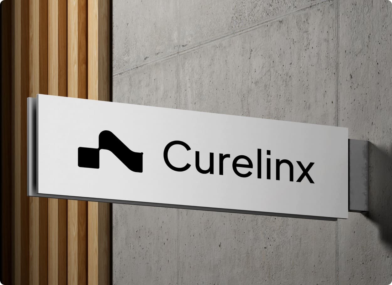 The Curelinx mark and wordmark on a white sign fixed to a concrete wall