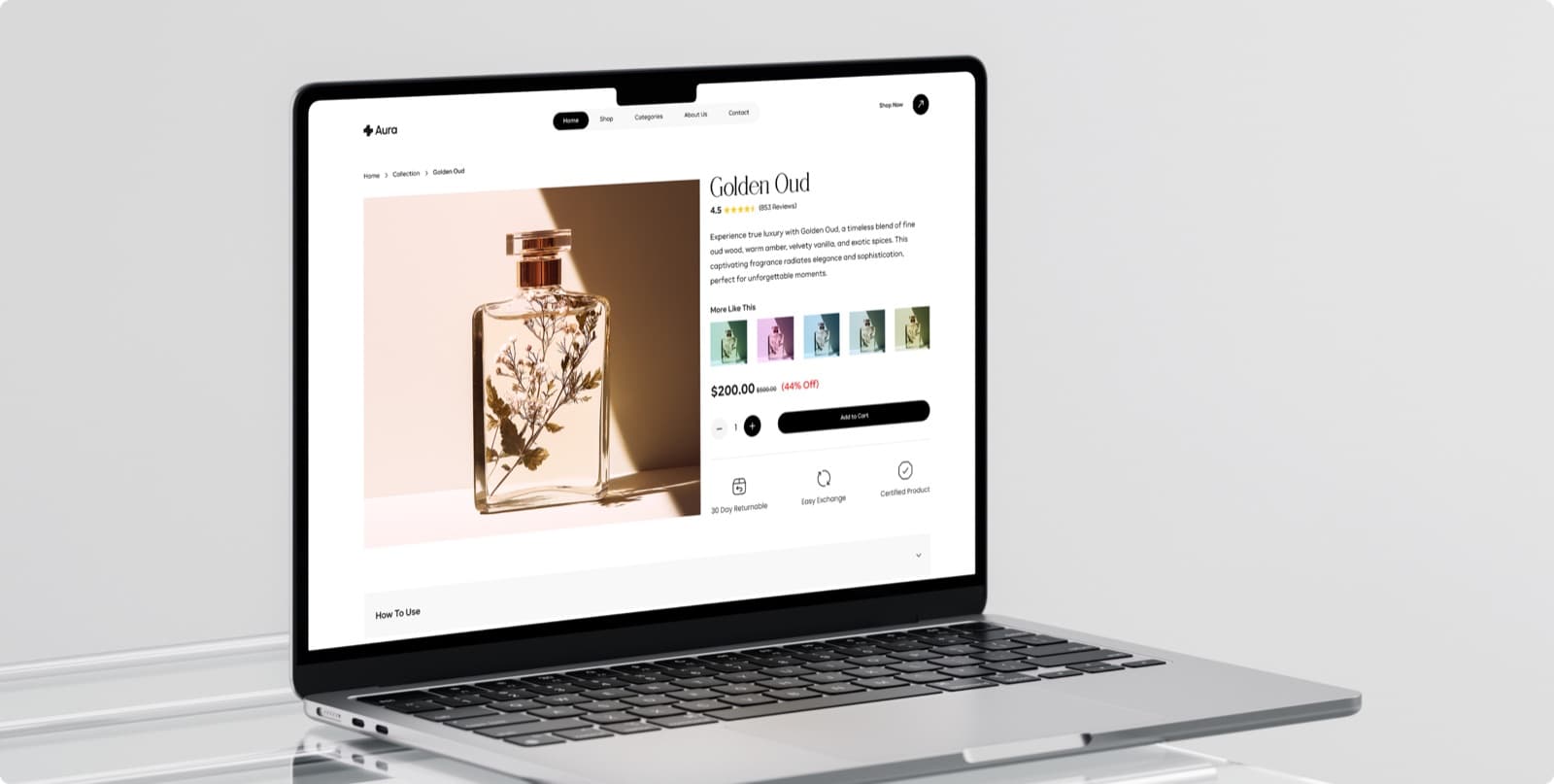 The Aura product page on a laptop, showing a perfume called Golden Oud with its rating, price and an Add to Cart button