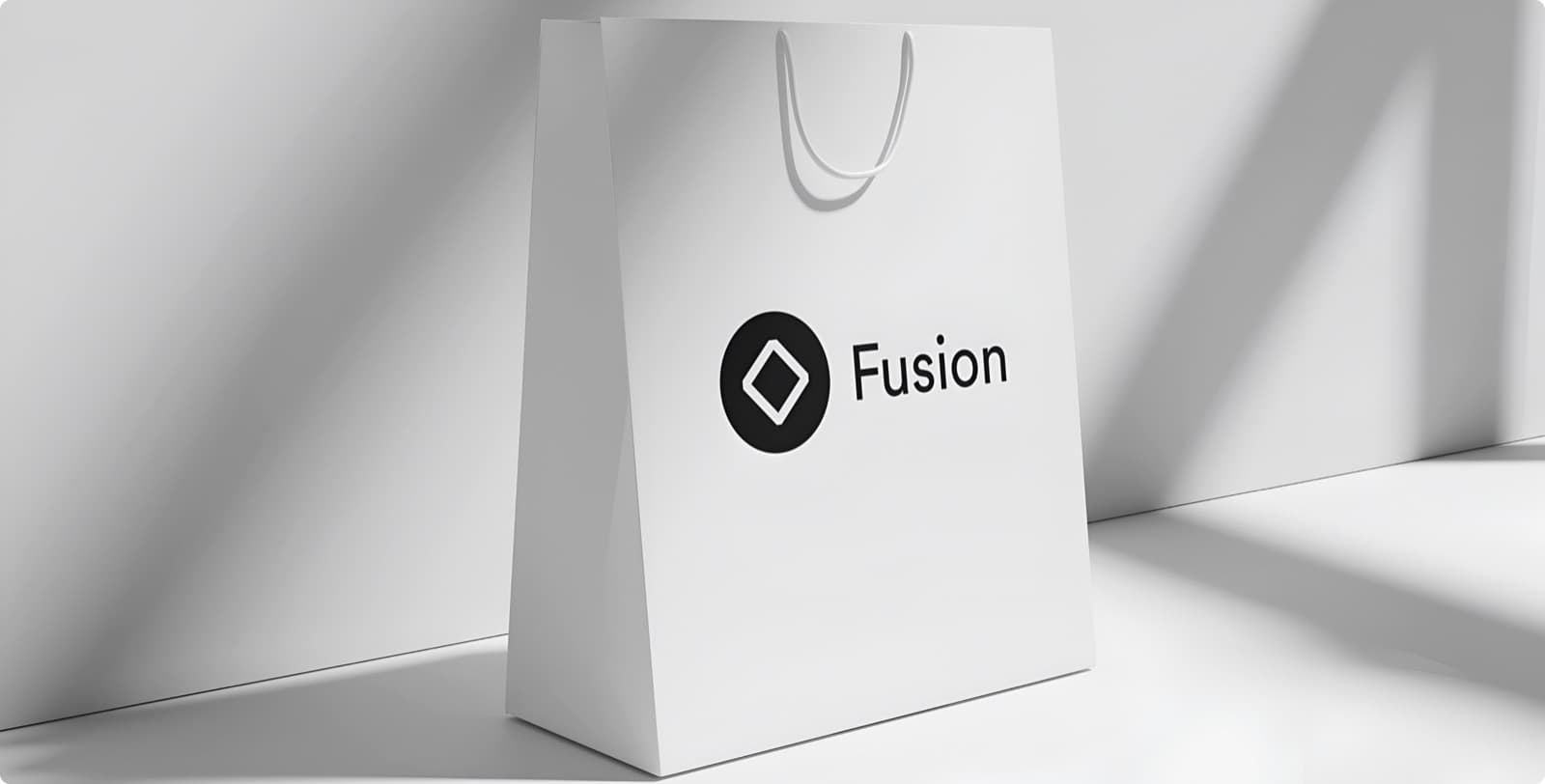 A white paper shopping bag carrying the Fusion mark and name