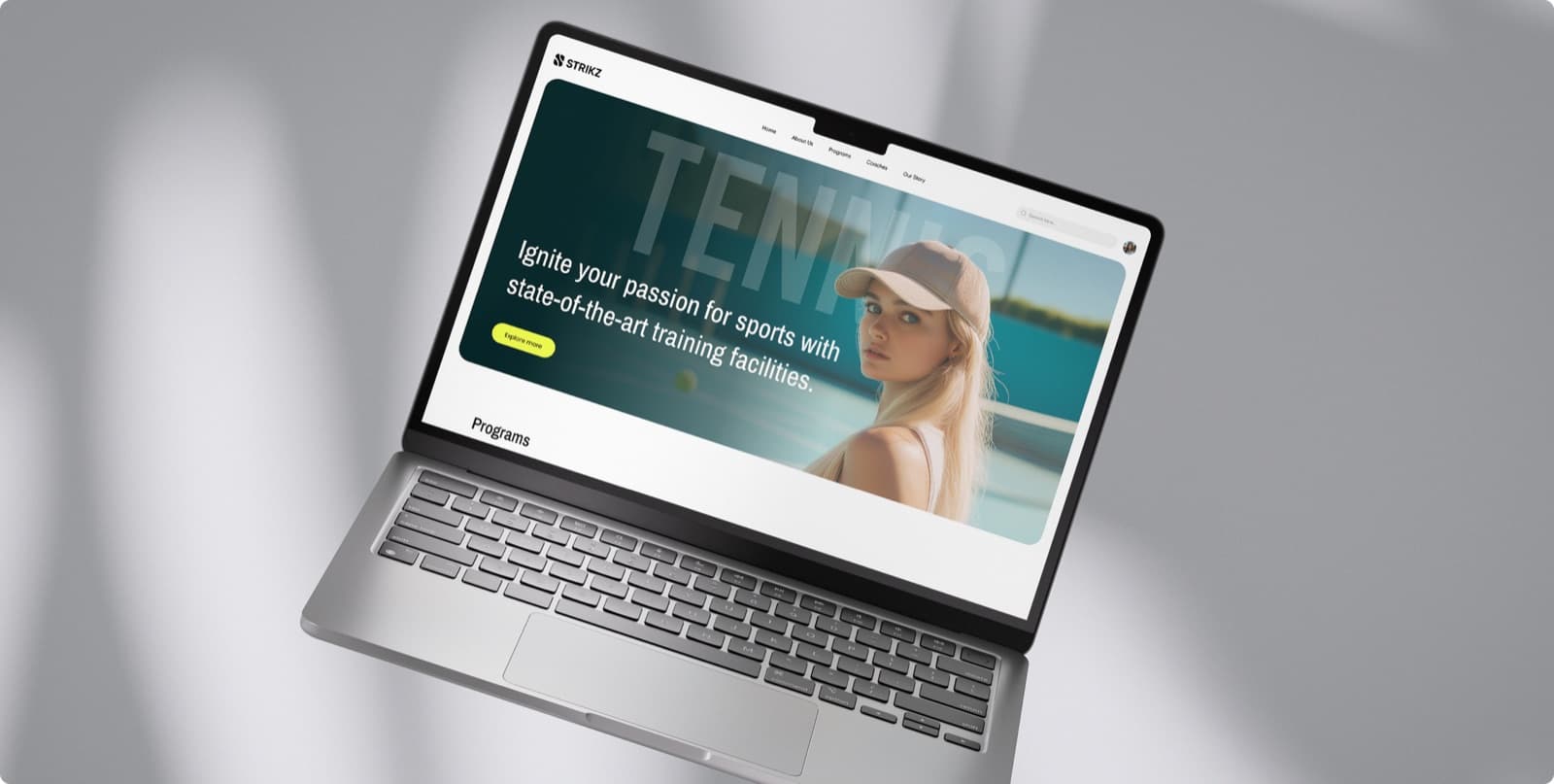 The Strikz website on a laptop, with the headline Ignite your passion for sports beside a tennis player on court