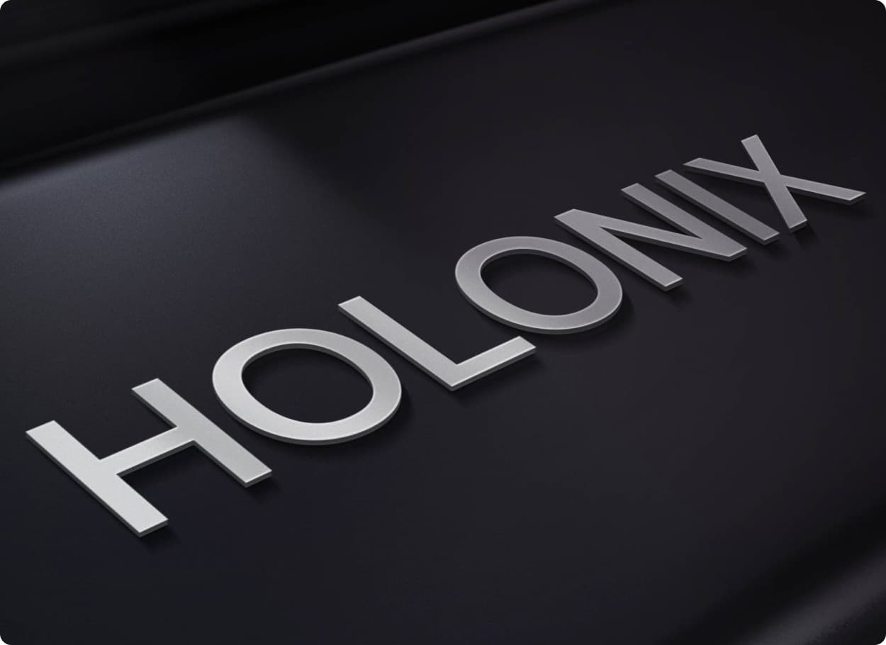 The Holonix wordmark as brushed metal letters on a black surface