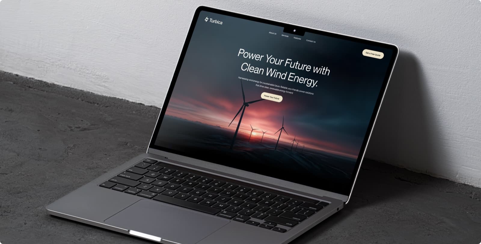 The Turbica website on a laptop against a white wall, with the headline Power Your Future with Clean Wind Energy over wind turbines at sunset