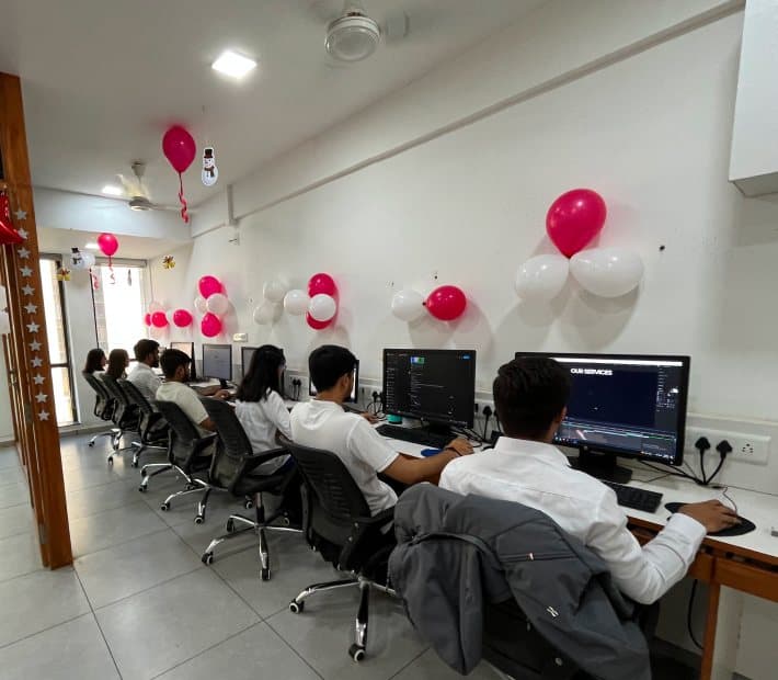 Team members working at their desks in the Redlio Labs office